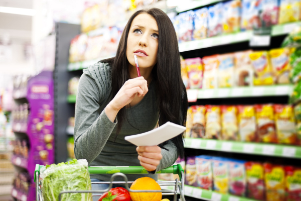 Etiqueta de/por com preco ancorado riscado ao lado do preco promocional em gondola de supermercado